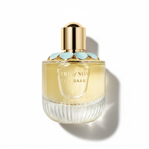 Elie Saab Girl of Now perfume bottle - professional top-down photography showing rounded glass with pale yellow liquid and gold cap with turquoise petals on white background