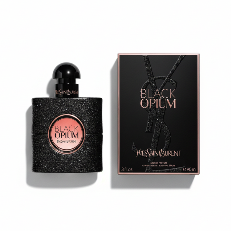 YSL Black Opium perfume held by elegant woman's hand with red manicure and gold jewelry against black velvet background